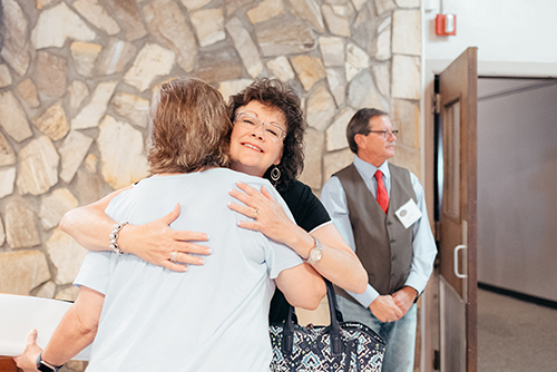Two people embracing in the church lobby